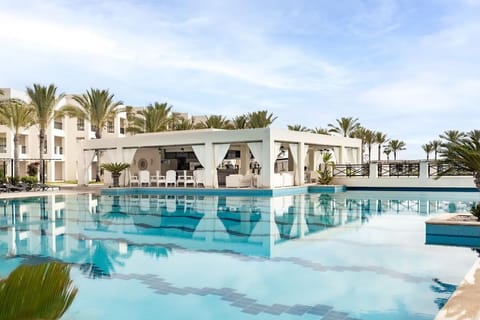 Unwind by the sparkling pool with shaded cabana seating.