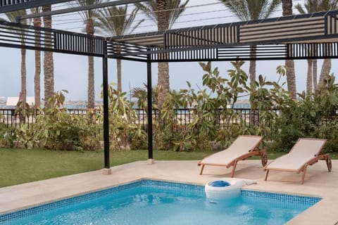 Soak up the sun beside the refreshing pool and loungers.