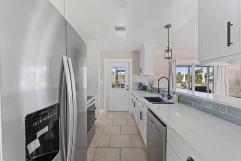 Well-equipped galley kitchen with stainless steel appliances and ample counter space—ideal for cooking fresh, local seafood.