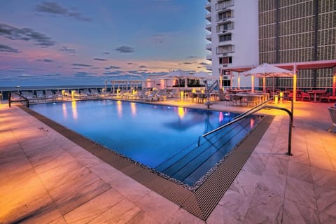 Stretch out on spacious deck seating beside the sunset pool.