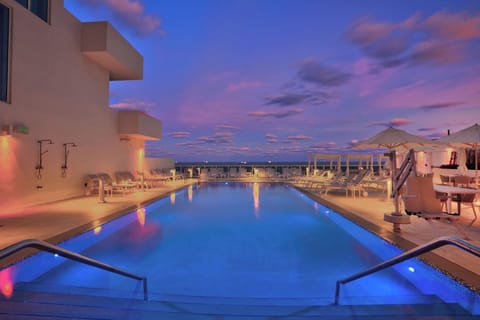 Soak in twilight calm as pool lights shimmer softly.