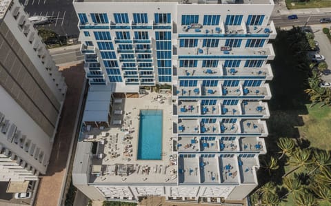 Dive into the sunny pool deck with plenty of loungers.