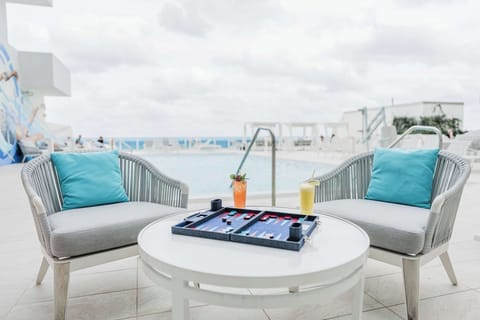 Sip cocktails poolside while the ocean sparkles beyond you.