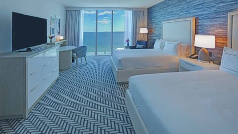 Relax in crisp linens with a serene waterfront backdrop.