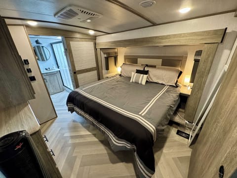 Comfortably walk around the king sized bed in the private master bedroom.