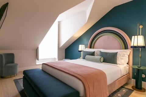 Unwind in a designer bed beneath dramatic arched headboard.
