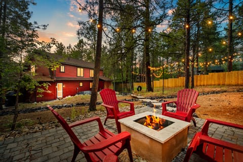Gorgeous backyard with a fire-table, trampoline, tire-swing and hammock