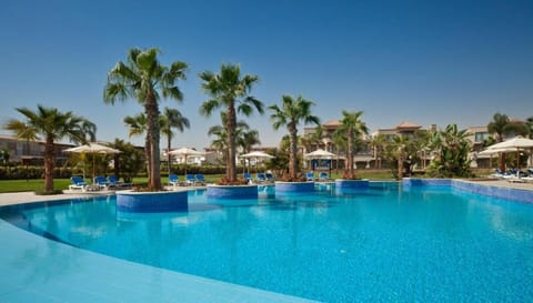 Swim laps in a calm pool with resort views.