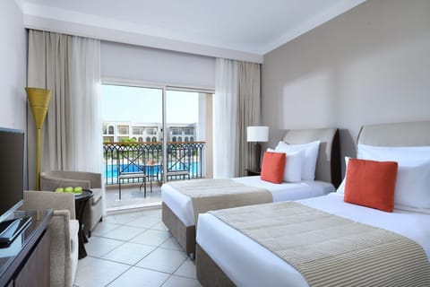 Drift off in crisp linens with a sparkling pool view.