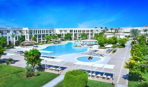 Dive into a sun-soaked resort pool oasis from above.