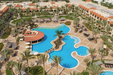 Dive into lagoon-style pools surrounded by swaying palms.