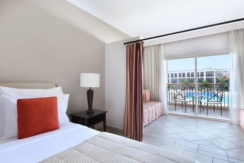 Recharge in a serene bedroom framed by airy balcony light.