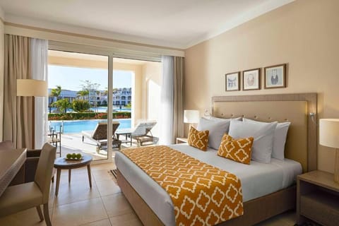 Unwind in a sunlit bedroom with direct poolside terrace access