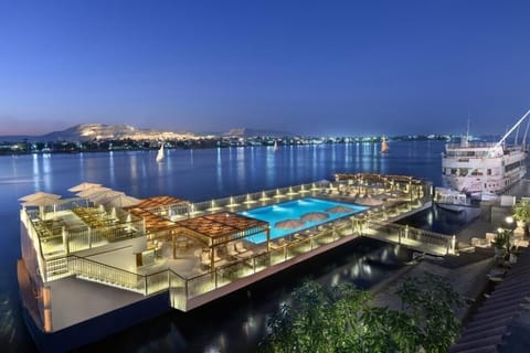 Dive into twilight serenity with glowing poolside river views.