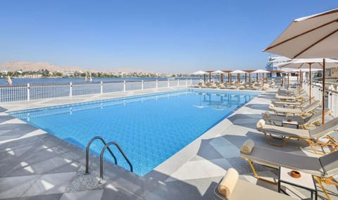 Soak up sunshine on loungers beside the sparkling infinity pool.