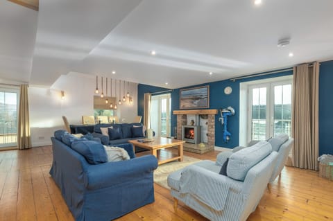 The large spacious living room with the log burning stove and dining area.