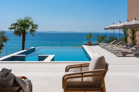 A 56 sqm heated infinity swimming pool (12m x 4.7m) with an advanced electrolysis filtering system