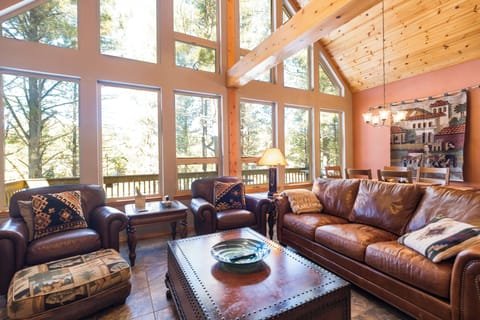 Living room with fireplace, dining room and open kitchen
