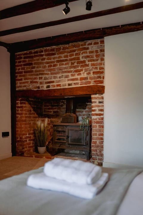 This double bedroom is located on the first floor in the main house, it has a Jack & Jill style ensuite shared with bedroom 3, It features a beautiful decorative fireplace (for display only), adding character and charm to the space