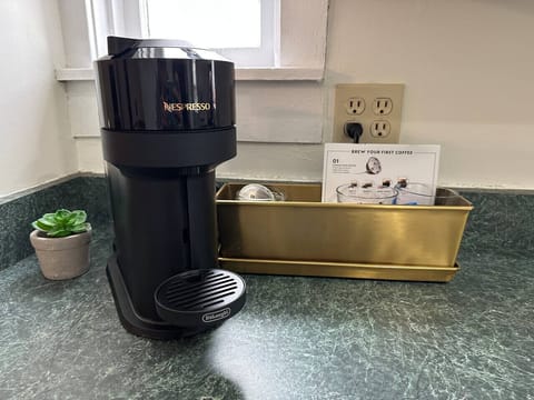 Nespresso Vertuo with a few pods, creamers and sugars to start your visit