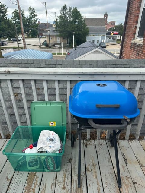 Charcoal grill and supplies on shared back deck