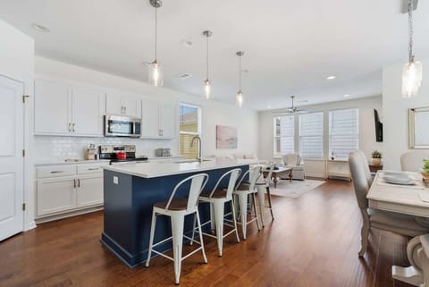 Open kitchen & dining space w/ island seating & modern finishes