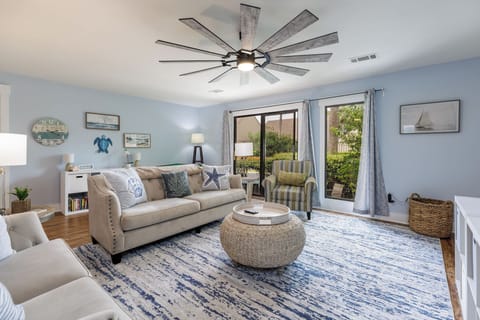 This bright, coastal-inspired living room invites you to relax in comfort after a day on the island.