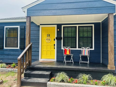 Enjoy morning coffee on this bright front porch.