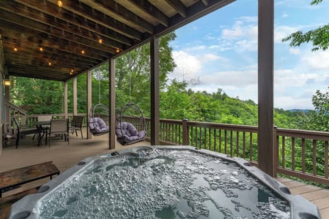 The lower level is where the fun continues — featuring a spacious dining deck and a bubbling hot tub, perfect for relaxing under the stars.