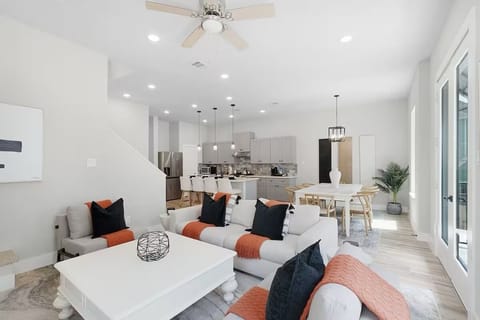 Bright open-concept living, dining, and kitchen space with modern furnishings