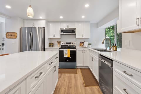 Bright and functional with white cabinetry, warm wood tones, and an inviting island for casual meals.