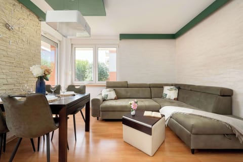 A cosy living room with a large corner sofa and natural daylight is the perfect spot to unwind after a busy day.