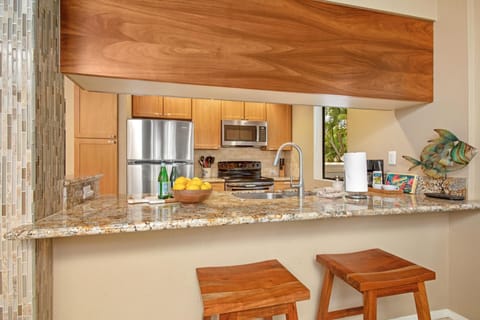 Bright kitchen with breakfast bar and wood cabinetry GCH-181