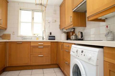 Kitchen with sink, washing machine and kettle