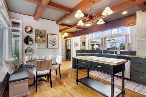 Bright kitchen with breakfast nook, butcher block island & sunny views!