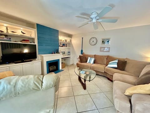 Living room with lots of seating, games, and cable tv.