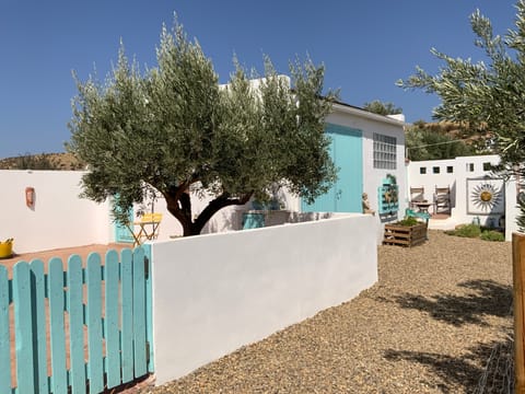 Gated Private garden with bistro table and chairs, sun loungers. Other seating area.