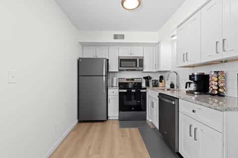 Modern kitchen equipped with stainless steel appliances and sleek cabinetry.