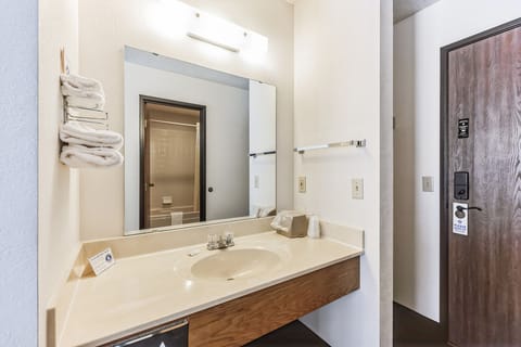 Each room is equipped with a convenient sink, mirrors, and towels located outside the bathroom.