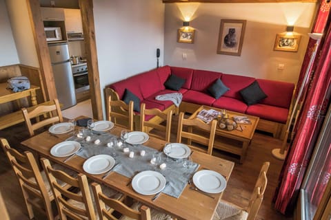 Spacious dining and lounge area with wooden furnishings and ample seating.