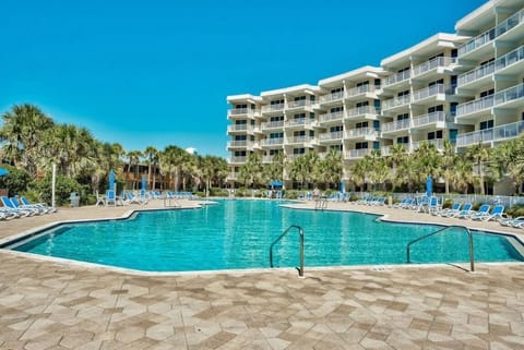 Resort-style pool surrounded by palm trees, perfect for cooling off after a sunny beach day.