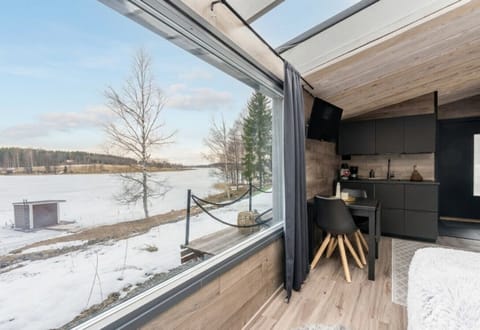 Enjoy a stunning, unobstructed view of the tranquil frozen lake and the Himos ski slopes right from your suite. The expansive glass windows perfectly frame the incredible scenery, allowing you to relax in warmth while surrounded by nature`s beauty.