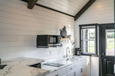 The kitchenette is equipped with a microwave, mini refrigerator, drip coffee maker, and hot plate.