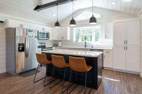 Gorgeous modern-style full-size kitchen stocked with basic amenities to make your vacation easier. There are 3 bar stools for an additional seating area, full size fridge, stove, and microwave.