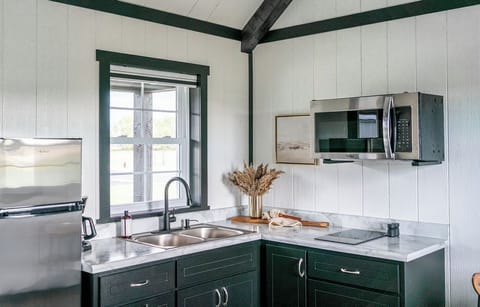 The kitchenette is equipped with a microwave, refrigerator, drip coffee maker, and hot plate.