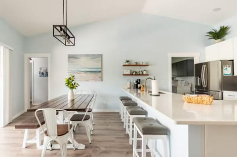 Dining area has 4 stools at the countertop