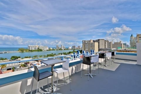 Sip cocktails at rooftop high-tops overlooking the water.
