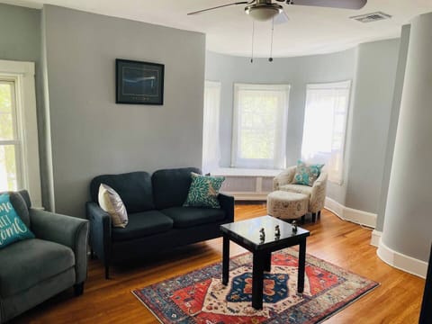 The living room comes furnished with essential pieces, including a comfortable sofa, a coffee table, and a TV, providing immediate comfort upon move-in.
