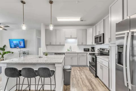 Experience the joy of cooking in this modern kitchen, where sleek countertops, state-of-the-art appliances, and plenty of storage make meal prep a breeze.