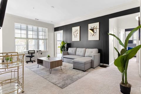 Kick back in a spacious living room with a plush sectional, Smart TV, and cozy throws.
